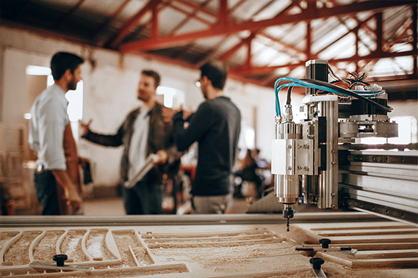 three men talking in a warehouse