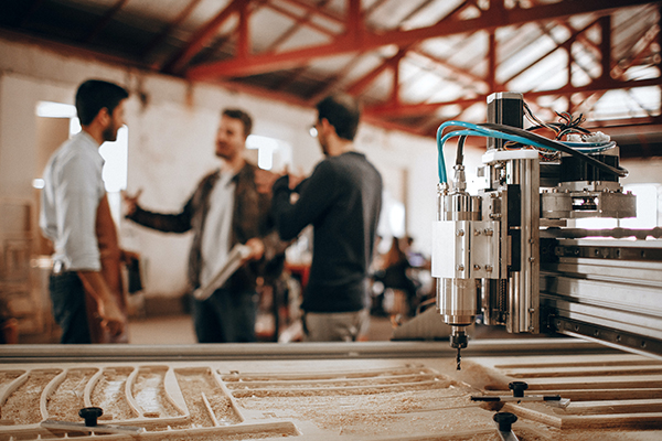 three men talking in a warehouse