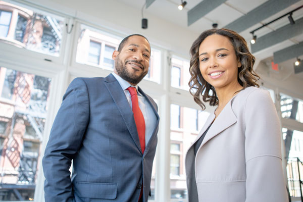 smiling man and woman in professional dress